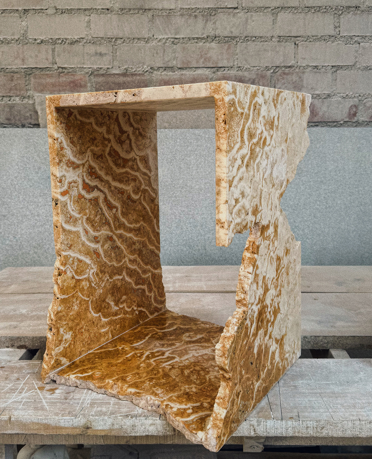 Frontal view of travertine sculpture RF Studio Salone Milan 2026
