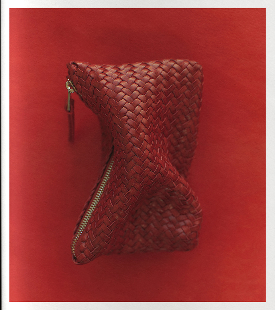 Woven nappa leather pouch bag in red on a red background