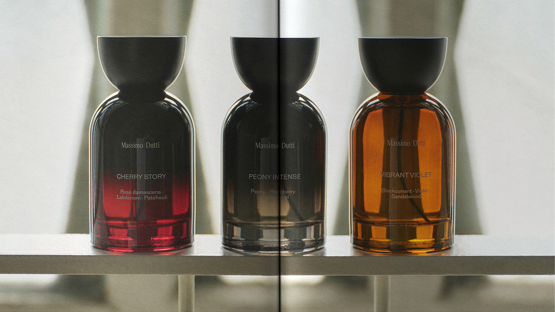 Three Massimo Dutti perfume bottles: Cherry Story, Peony Intense and Vibrant Violet on a shelf