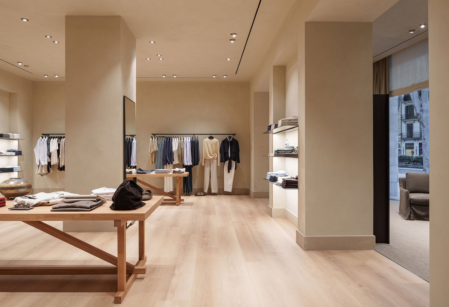 Massimo Dutti Mallorca store interior with central table, wooden furniture and window display area