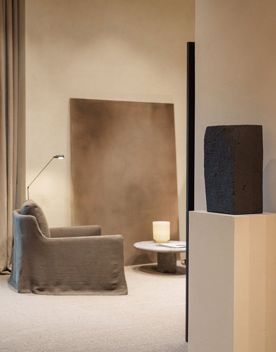 Massimo Dutti Mallorca store interior with armchair, lamp, artwork and sculpture on pedestal