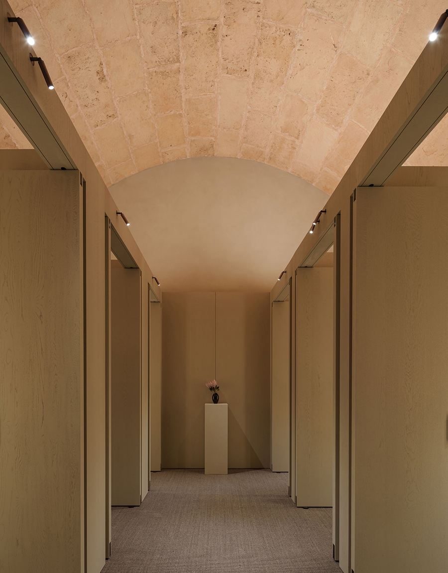 Massimo Dutti Mallorca store interior with corridor, vaulted ceiling and warm lighting