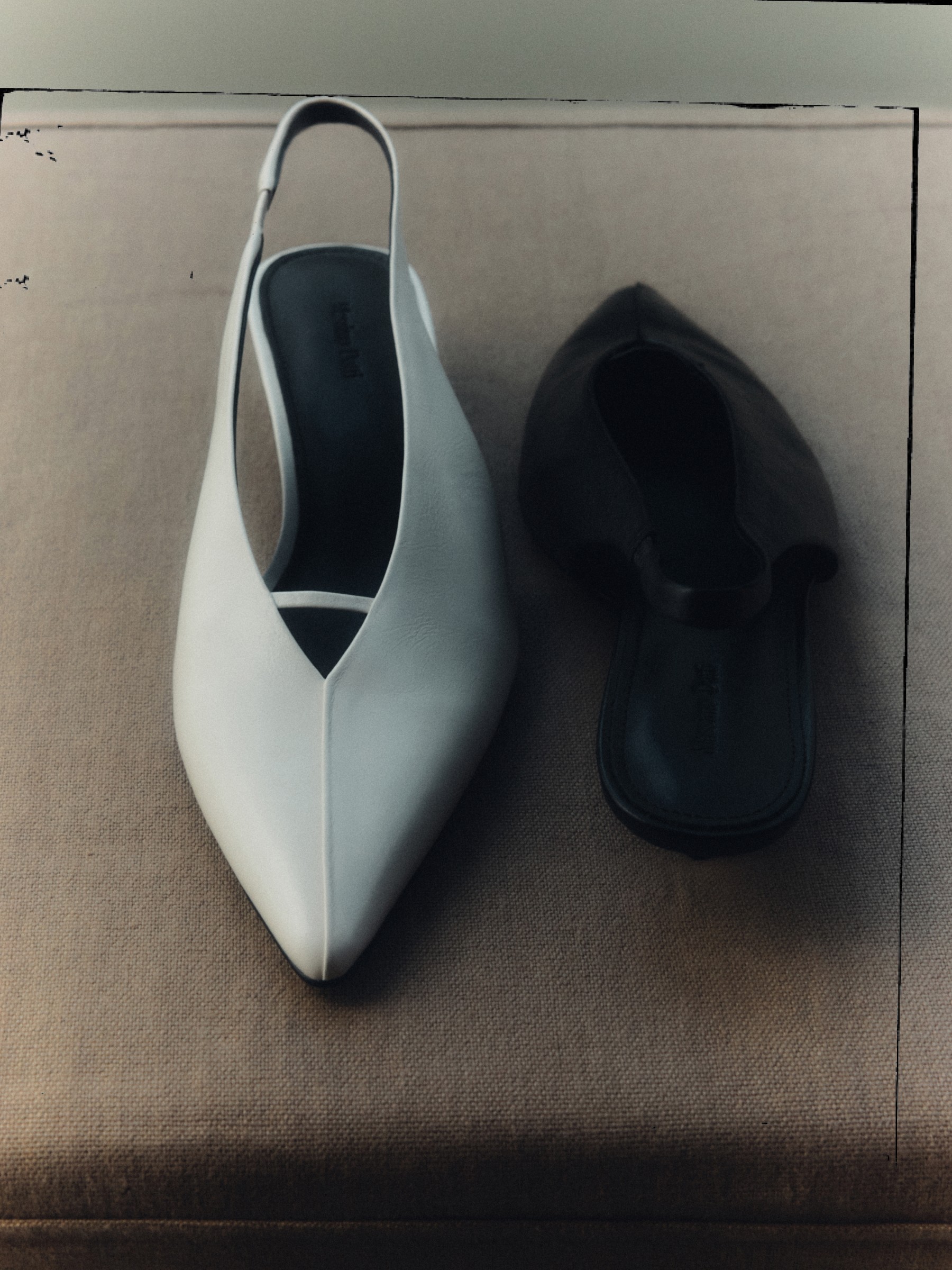 White slingback heel next to a black ballet flat — Massimo Dutti