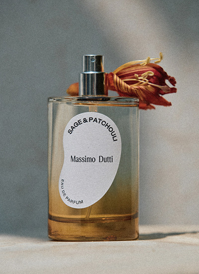 Sage & Patchouli eau de parfum bottle beside a dried flower — Massimo Dutti