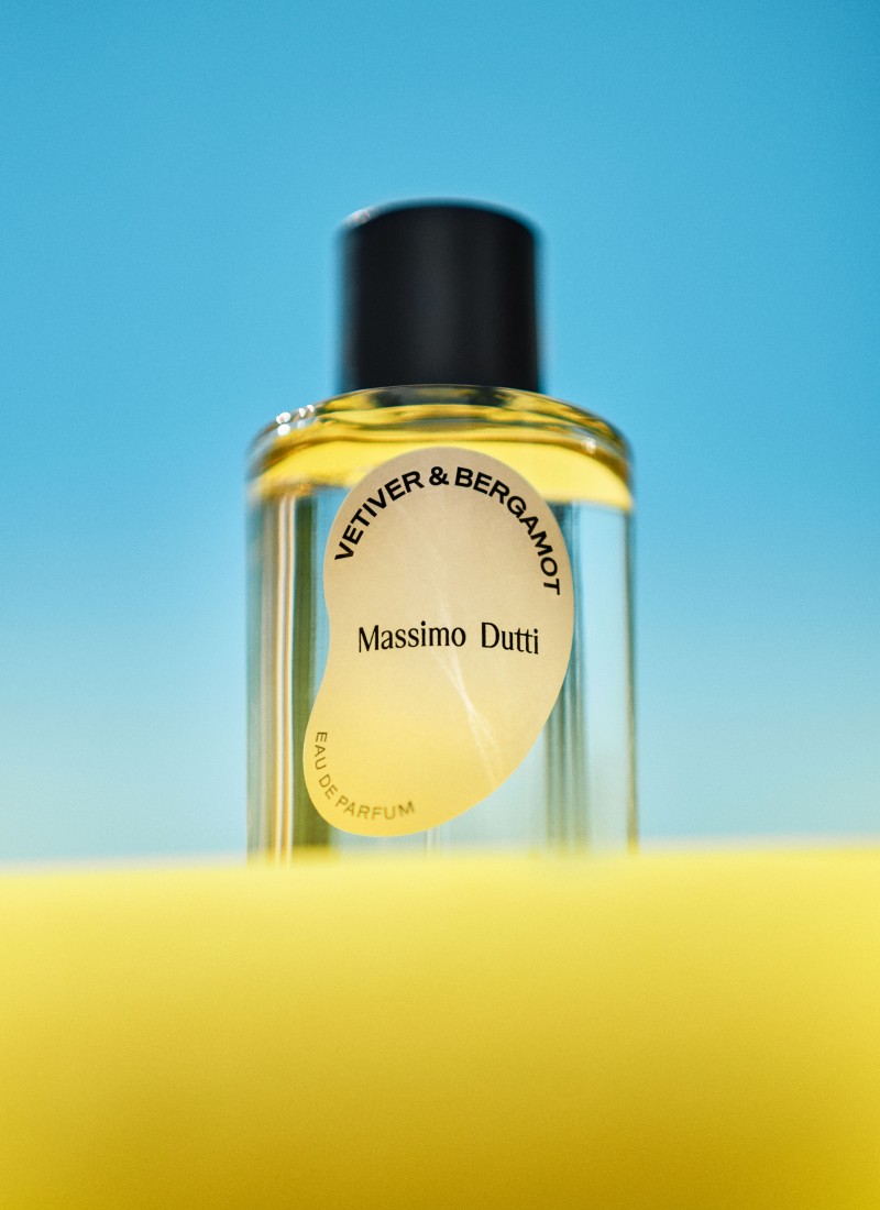 Vetiver & Bergamot eau de parfum bottle against a yellow background and blue sky — Massimo Dutti