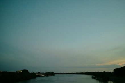 The Rhône at dusk with the city in the background — Arles