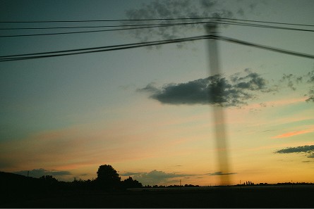 Cloud and power lines above the horizon at sunset — Arles