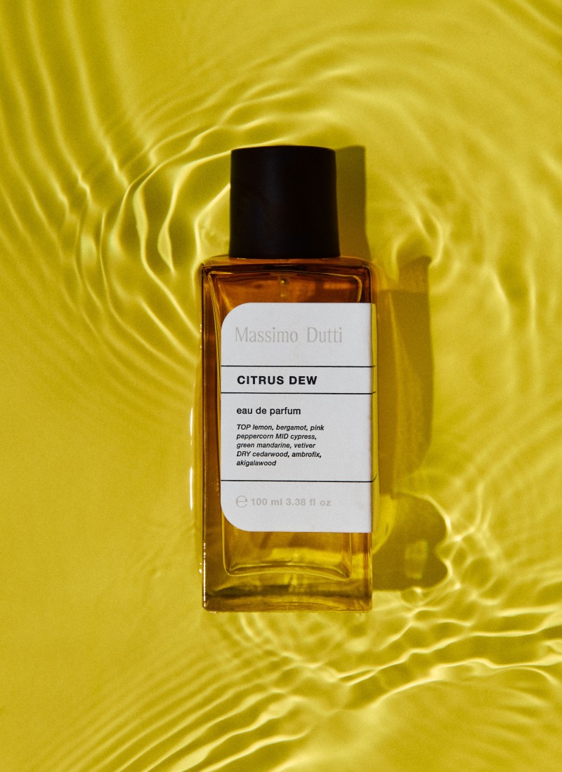 Citrus Dew eau de parfum bottle on yellow water with reflections — Massimo Dutti