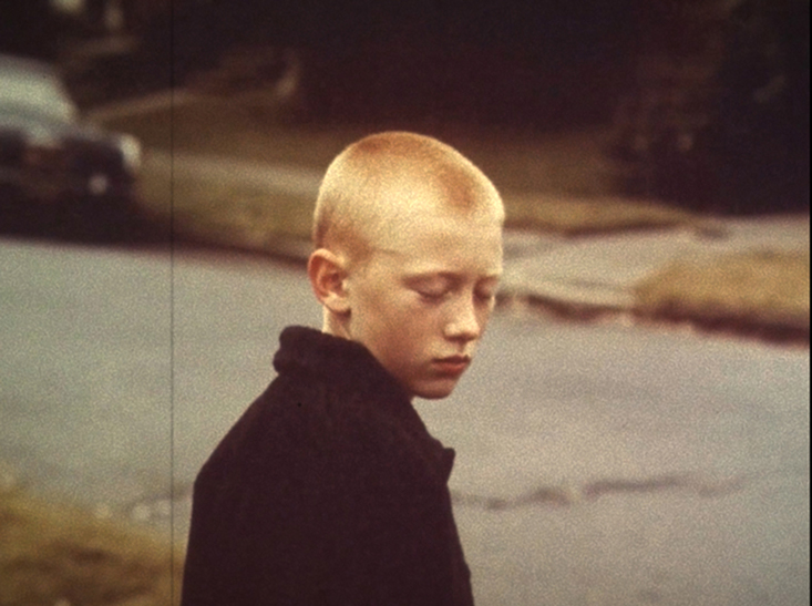 Still from Memory Palace by Clément Cogitore: boy beside a road — Massimo Dutti