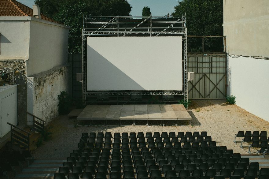 Screen and seats of an open-air summer cinema — Arles