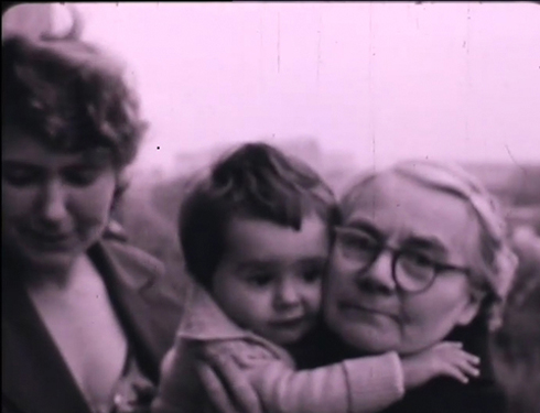 Still from Memory Palace by Clément Cogitore: family embracing in pink tones — Massimo Dutti