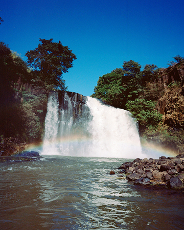 Waterfall with a rainbow in Ampefy, Madagascar, photograph by Charlotte Yonga — Massimo Dutti