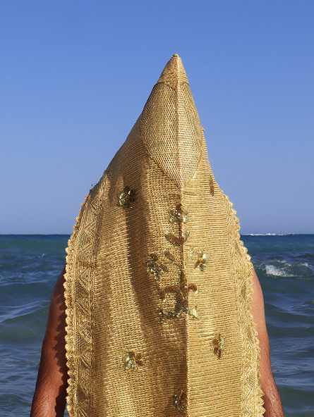 Figure with a golden headpiece facing the sea, Amen by Amira Lamti — Massimo Dutti