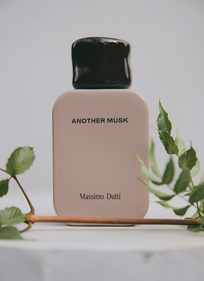 Another Musk eau de parfum bottle among green leaves — Massimo Dutti
