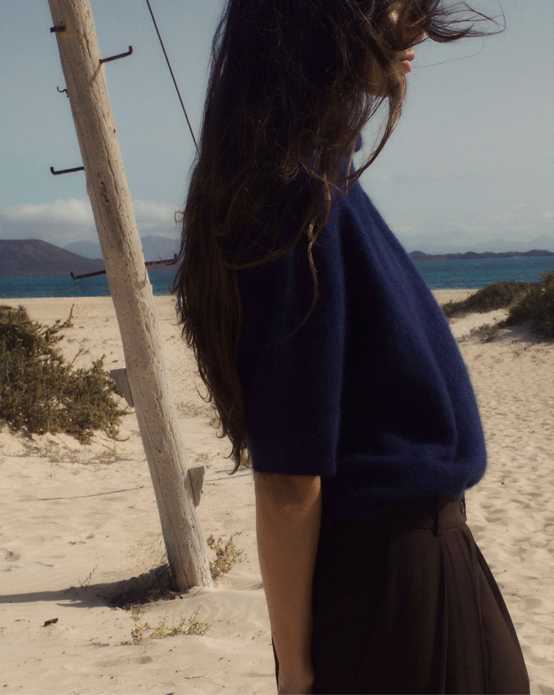 Model in a turtleneck sweater and wide-leg trousers in the volcanic landscape, Fuerteventura — Massimo Dutti