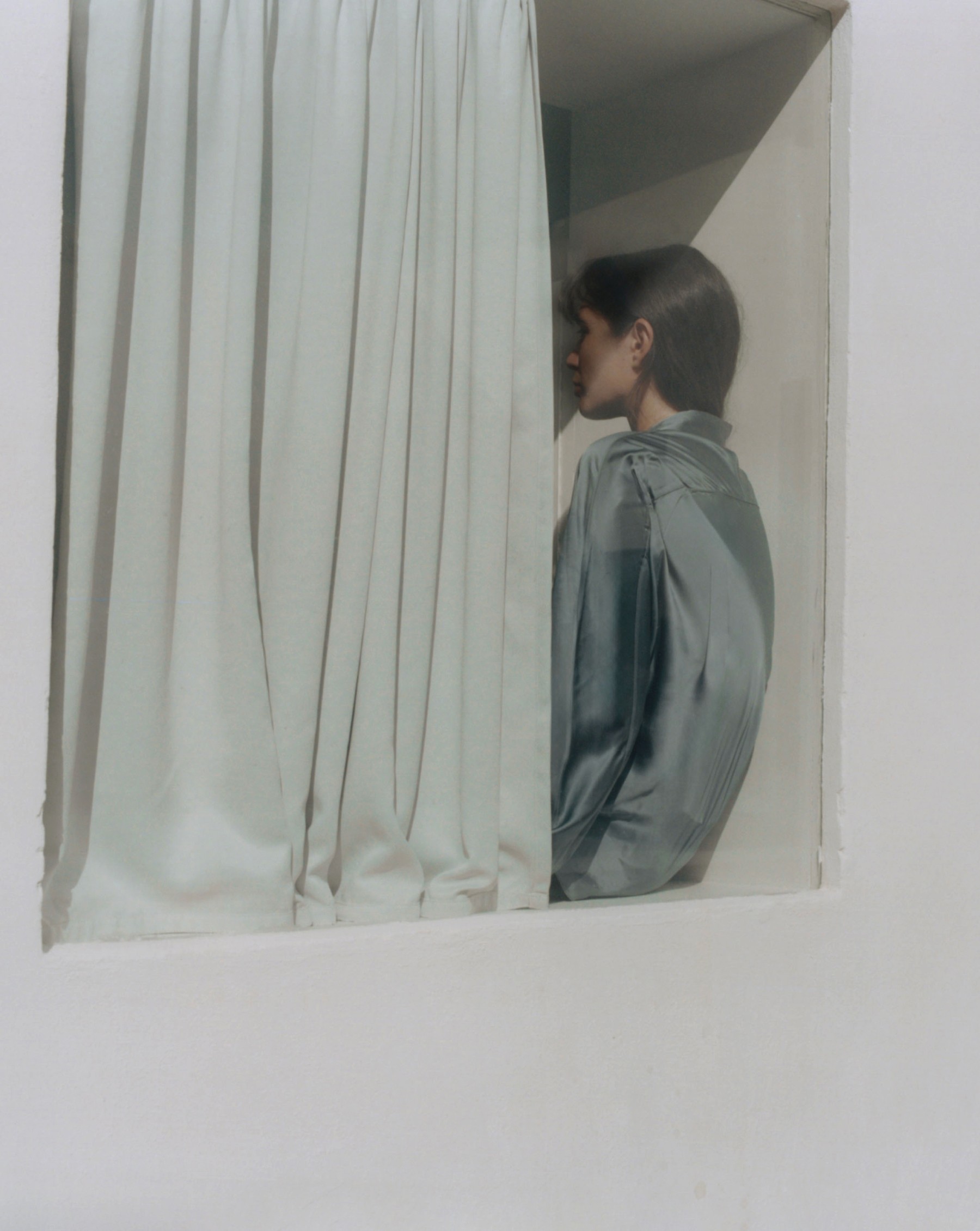 Model in a satin shirt behind a linen curtain, Fuerteventura — Massimo Dutti