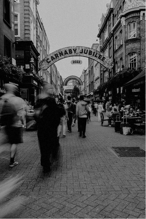 People walking under the Carnaby Street arch, in black and white — Massimo Dutti London Fashion Week