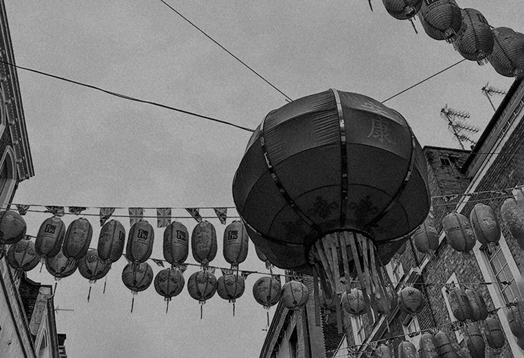 Chinatown lanterns against the sky, in black and white — Massimo Dutti London Fashion Week