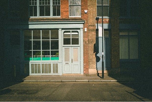 Green shopfront lit up at night in Shoreditch — Massimo Dutti London Fashion Week