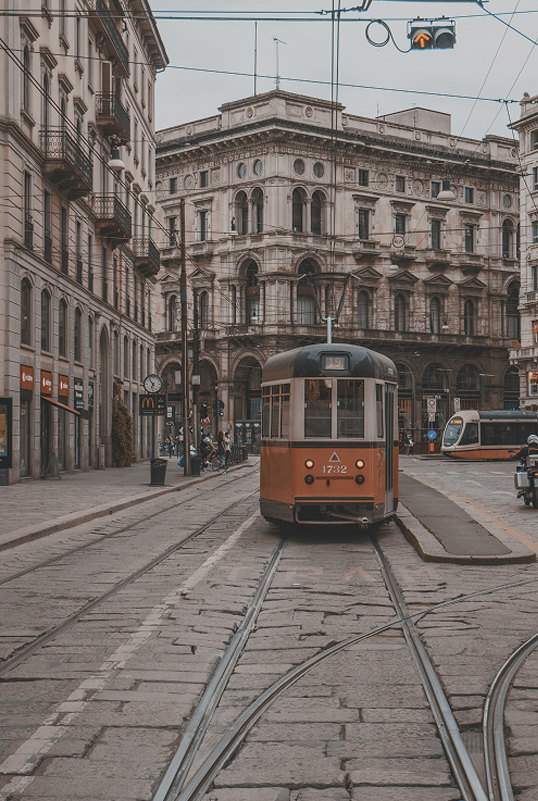 Historic orange tram on a cobbled street in central Milan — Massimo Dutti Milan Fashion Week