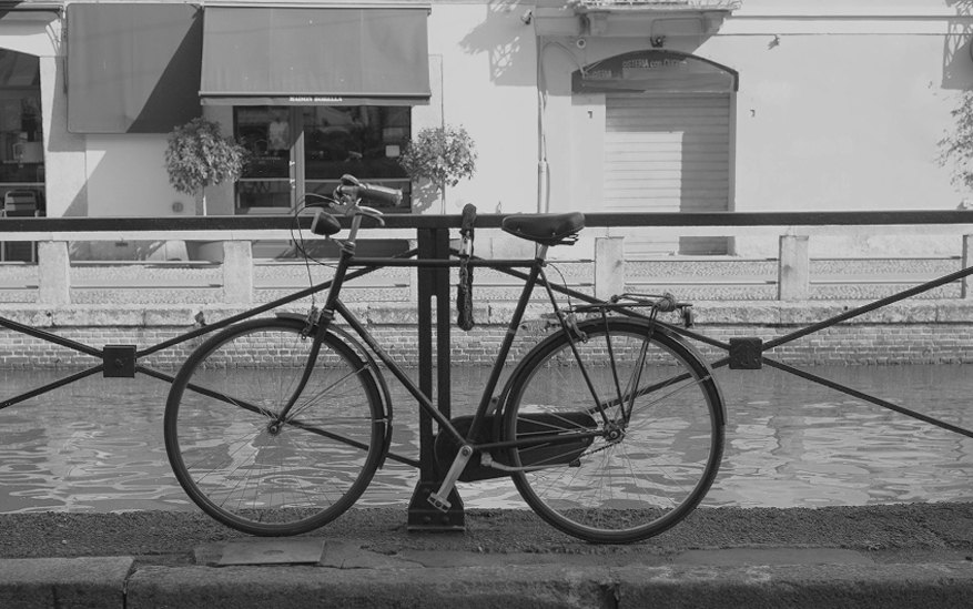 Bicycle leaning on the canal railing, in black and white — Massimo Dutti Milan Fashion Week