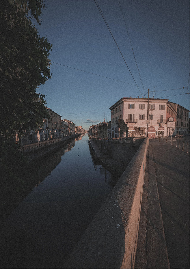Canal at dusk with tram wires above the water — Massimo Dutti Milan Fashion Week