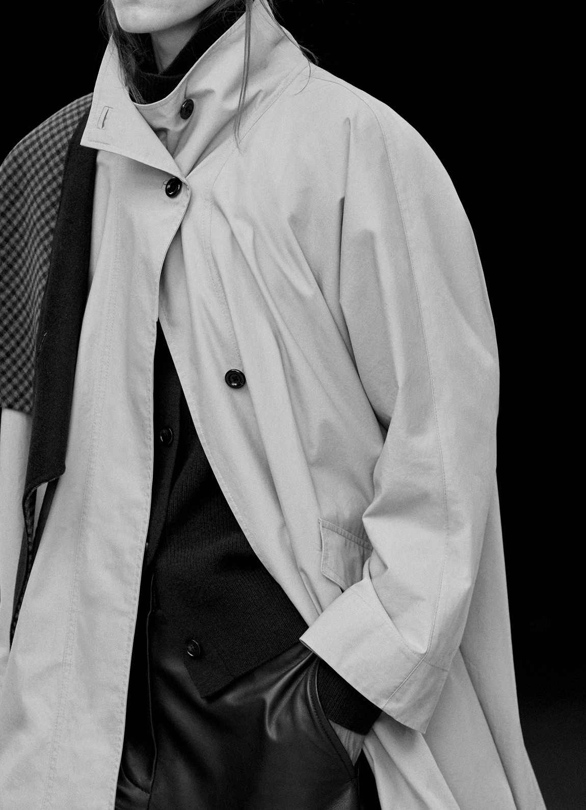 Light grey trench coat over a black cardigan and leather trousers, in black and white — Massimo Dutti The Trench Edit