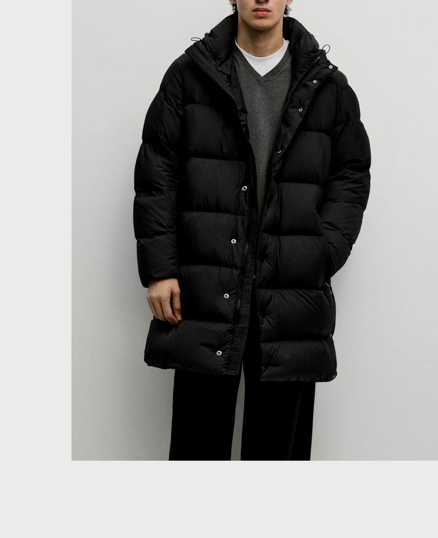 Man wearing a long black hooded puffer jacket — Massimo Dutti Puffer Jackets