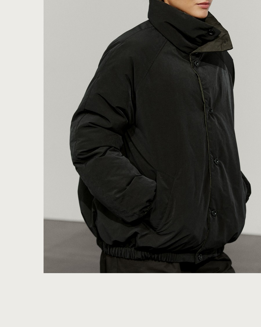 Woman wearing a dark brown high-collar reversible puffer jacket — Massimo Dutti Puffer Jackets