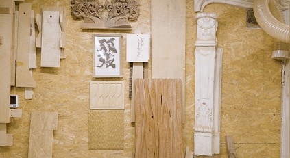 Wall of Igor Polasiak’s studio with wood, stone and sketches
