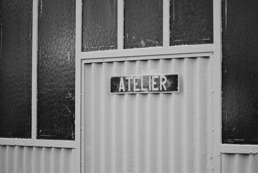 Studio door with an Atelier sign in Belleville, in black and white — Massimo Dutti Paris Fashion Week