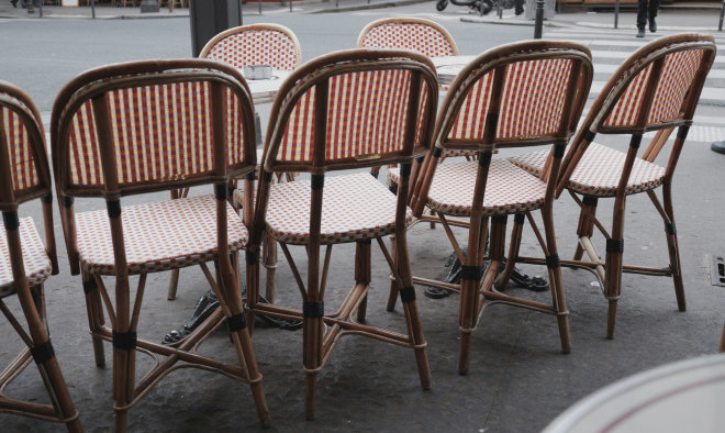 Rattan bistro chairs on a café terrace in the Marais — Massimo Dutti Paris Fashion Week