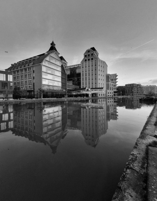 The Grands Moulins de Pantin reflected in the canal, in black and white — Massimo Dutti Paris Fashion Week