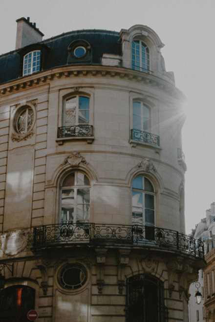Haussmann-style corner building with wrought-iron balcony in Saint-Germain — Massimo Dutti Paris Fashion Week