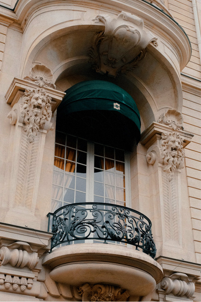 Ornate window with green awning and wrought-iron balcony in Saint-Germain — Massimo Dutti Paris Fashion Week