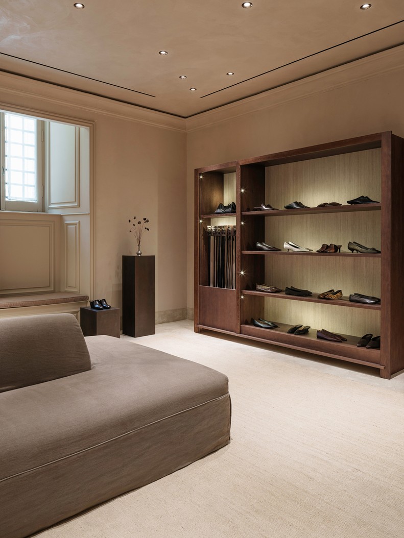 Illuminated footwear shelving beside a window — Massimo Dutti Rome