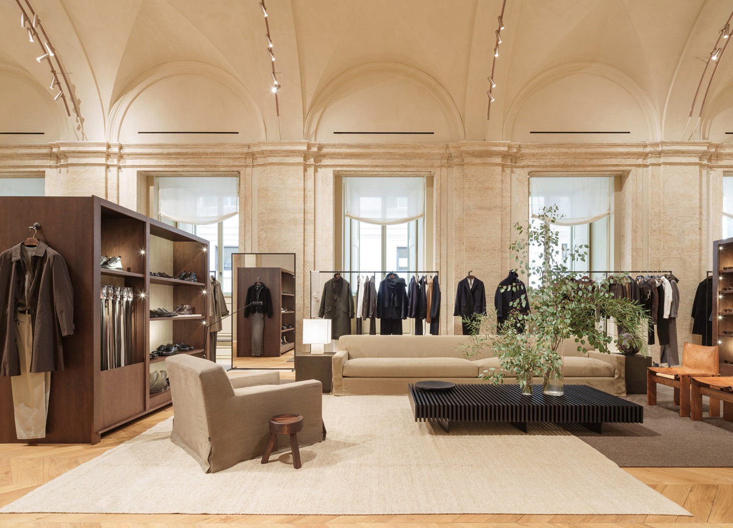 Menswear room with vaults, clothing rails, a sofa and wooden shelving — Massimo Dutti Rome