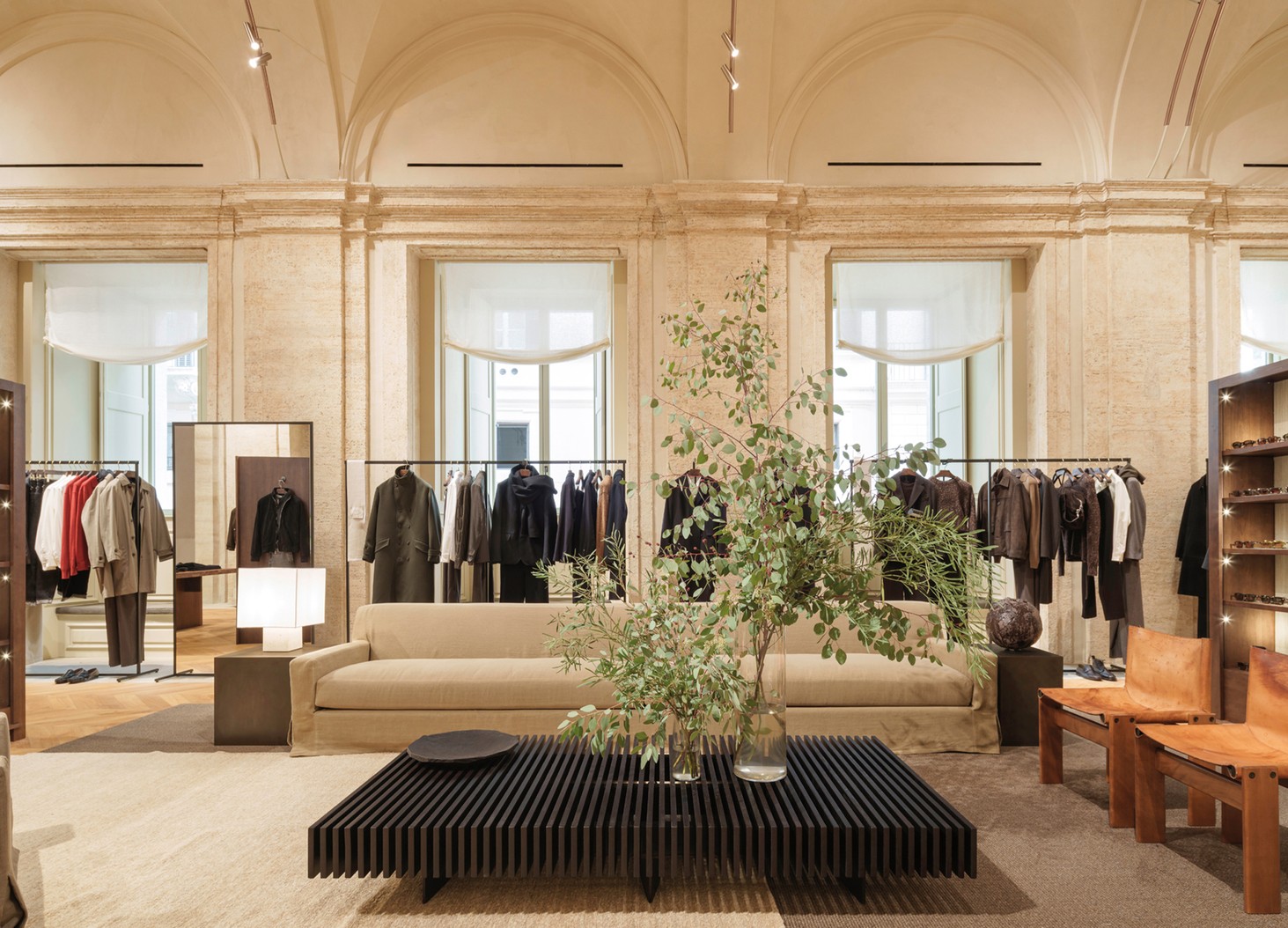 Menswear room with large windows, clothing rails and a seating area — Massimo Dutti Rome