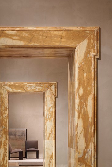 Yellow marble doorframe between two rooms — Massimo Dutti Rome