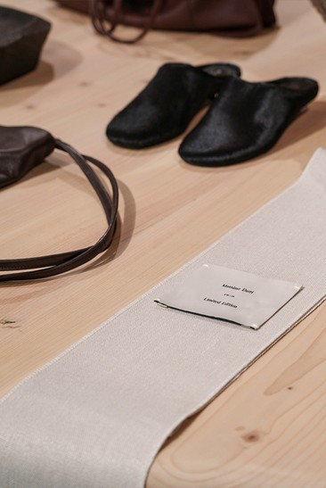 Loafers and leather accessories on a wooden table — Massimo Dutti Rome